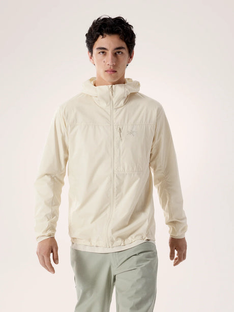 Person wearing a light-colored jacket on a plain background - Arc'teryx Squamish Hoody (Men's) - Sea Salt