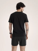 Man wearing a black t-shirt and shorts on a beige background - Arc'teryx Norvan Downword Logo Shirt Short Sleeve (Men's) - Black