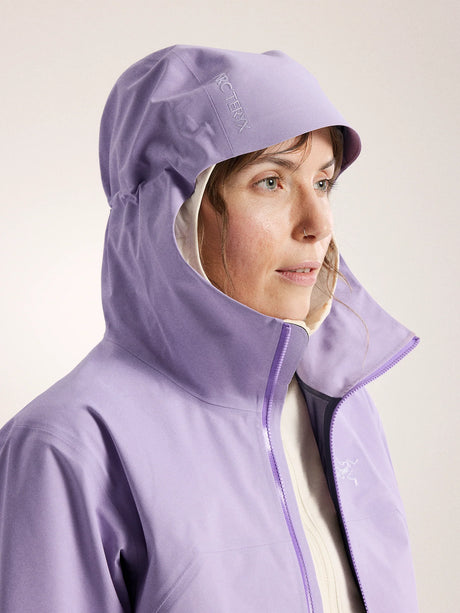Person wearing a light purple hooded jacket with a visible brand logo on a plain background - Arc'teryx Beta Jacket (Women's) - Mallow
