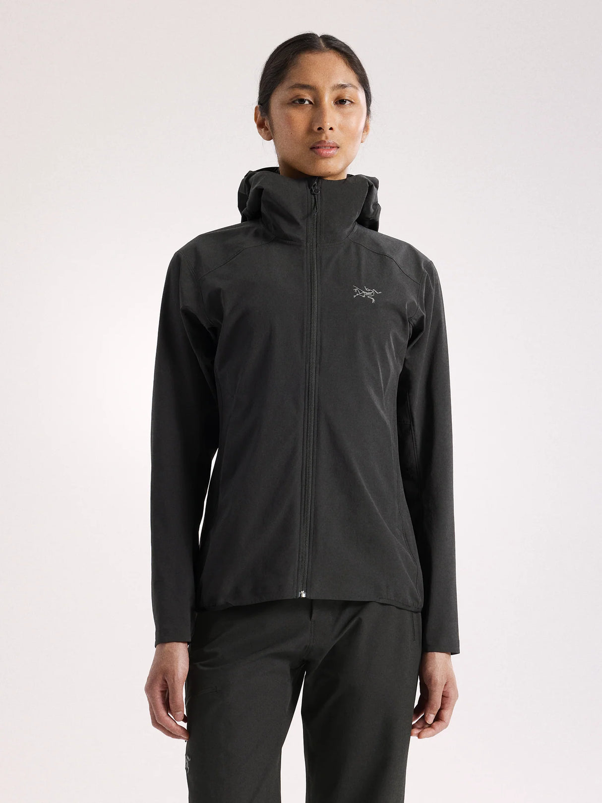 Person wearing a black jacket with a brand logo on a white background - Arc'teryx Gamma Lightweight Hoody (Women's) - Black