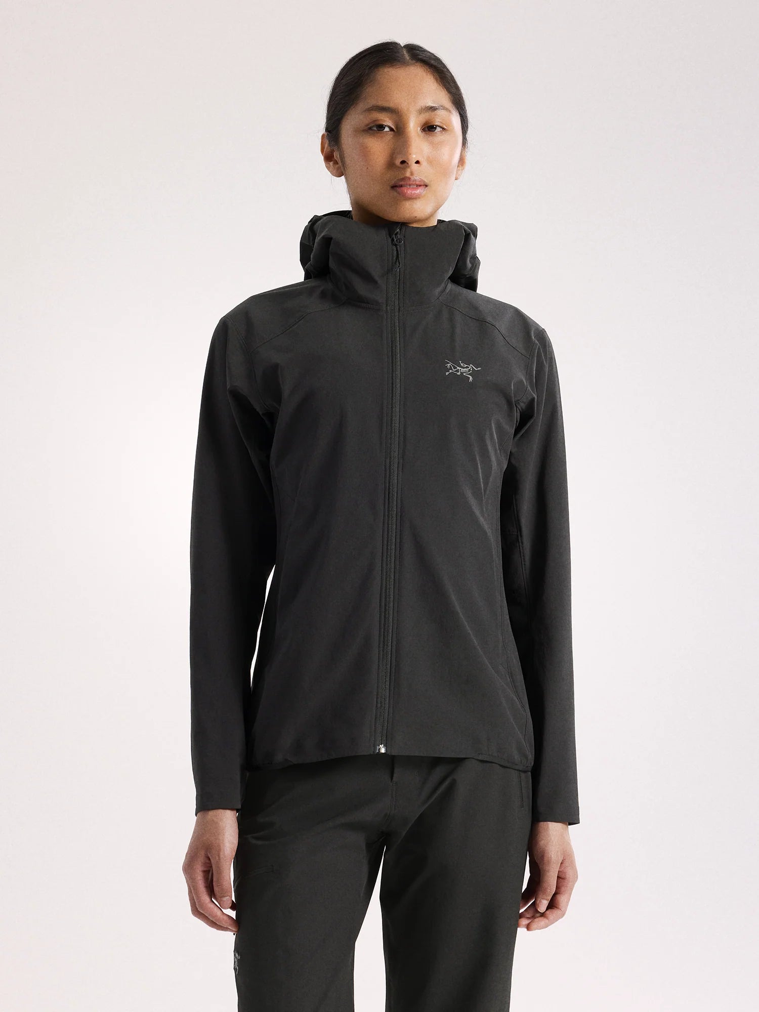 Person wearing a black jacket with a brand logo on a white background - Arc'teryx Gamma Lightweight Hoody (Women's) - Black