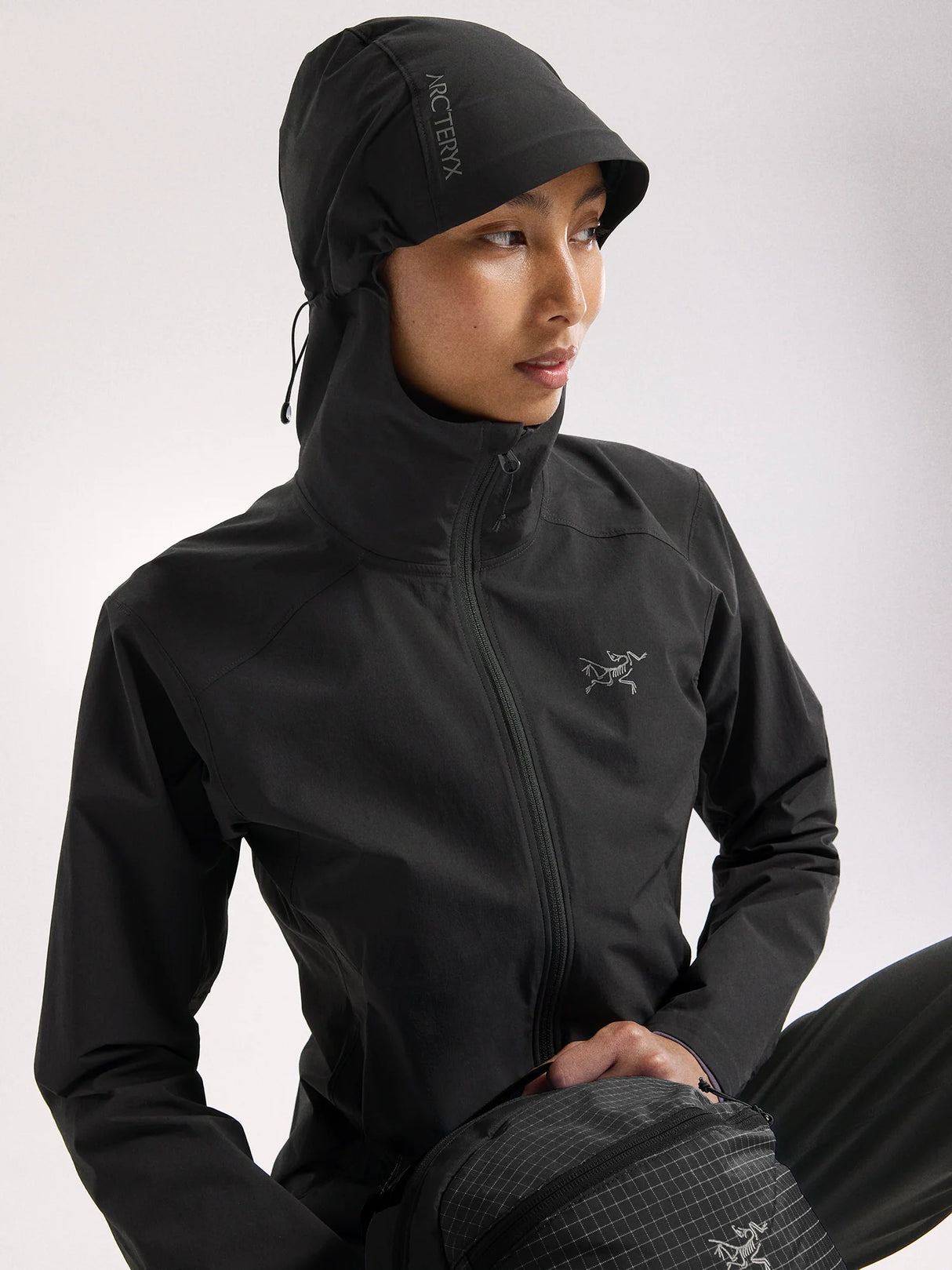 Person wearing a black jacket with a hood on a white background - Arc'teryx Gamma Lightweight Hoody (Women's) - Black