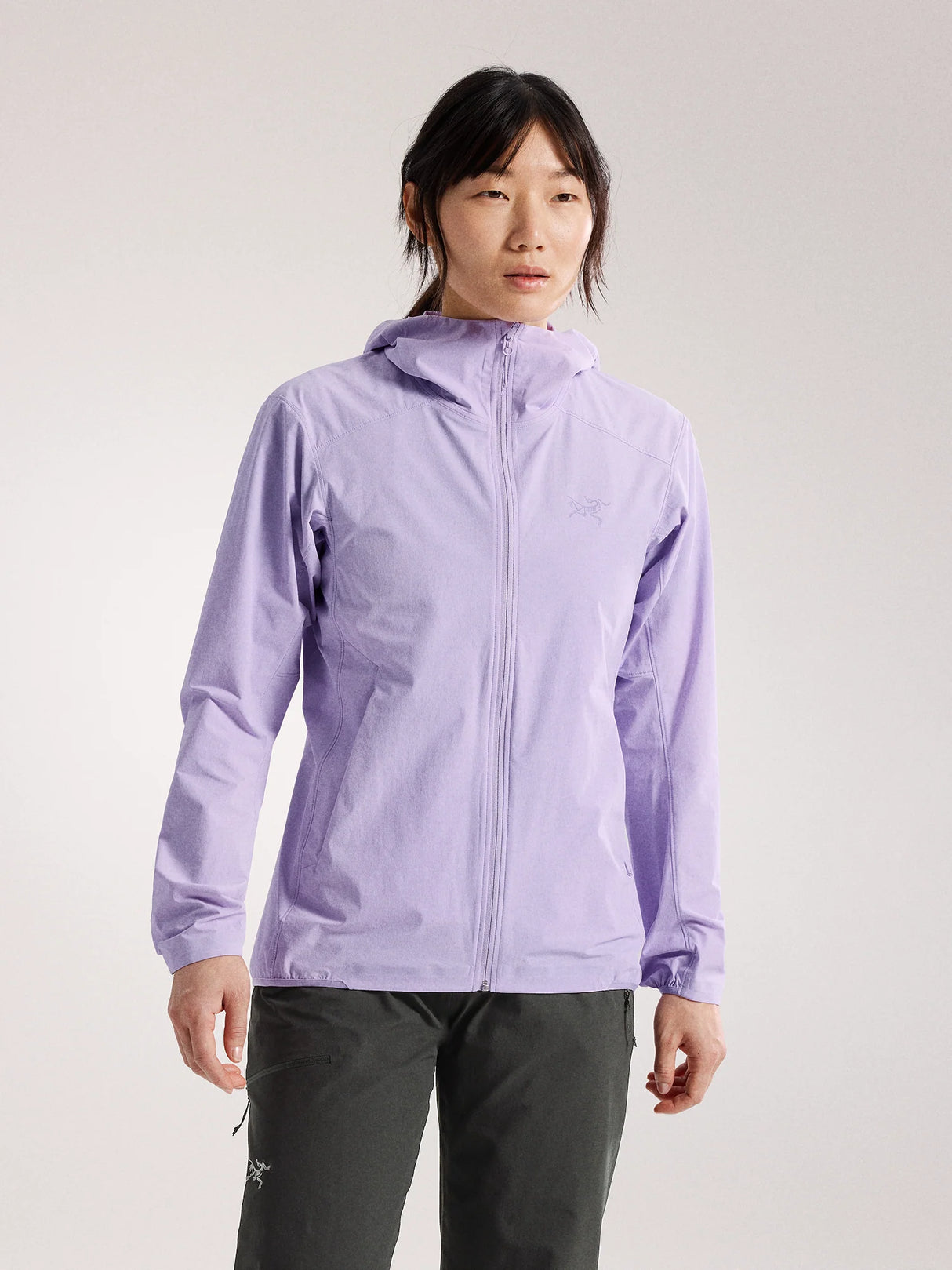 A woman modeling a light purple hooded zip-up jacket against a plain light gray studio background. - Arc'teryx Gamma Lightweight Hoody (Women's) - Mallow