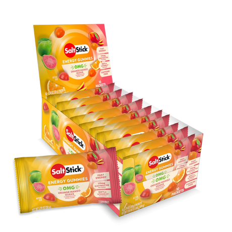 A retail display box and individual packets of SaltsStick Energy Gummies in orange flavor, arranged on a clean white background. - SaltStick Energy Gummies - OMG! Orange, Mango, Guava - 10 Pack