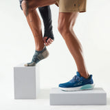 Person wearing blue running shoes on a white background - Smartwool Hike Targeted Cushion Low Ankle Socks (Unisex) - Twilight Blue