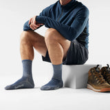 Person wearing blue socks with a white background and brown shoes on the side - Smartwool Hike Classic Edition Light Cushion Crew Socks (Unisex) - Alpine Blue