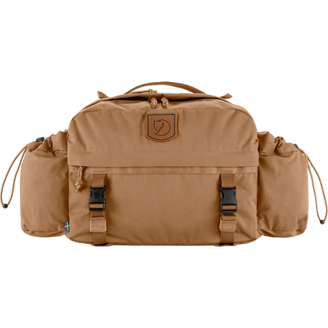 A tan Fjälör outdoor duffel bag with side pockets, front utility straps, and a brown leather logo patch on a white background. - Fjällräven Singi Hip Pack 10 - Khaki Dust