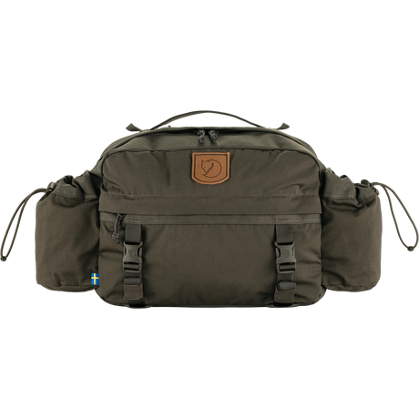 An olive green Fjälleväl outdoor bag with a brown leather brand patch on the front, side pockets, and adjustable buckle straps, shown against a plain white background. - Fjällräven Singi Hip Pack 10 - Dark Olive