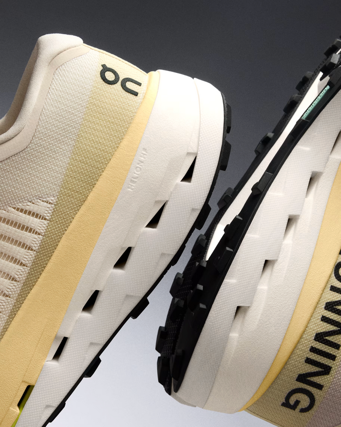 Close-up of a TRAIL running shoe, more specific the ON cloudultra pro with a focus on the sole and brand logo.