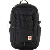 A black Fjälör backpack with multiple zippered compartments, compression straps, and a signature red heart logo patch on the front pocket, shown against a plain white background. - Fjällräven Skule 20 Backpack - Black