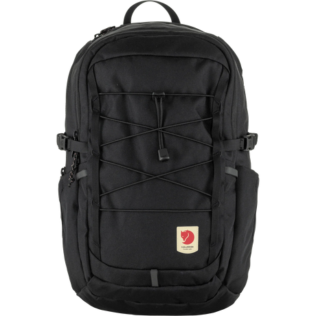 A black Fjälör backpack with multiple zippered compartments, compression straps, and a signature red heart logo patch on the front pocket, shown against a plain white background. - Fjällräven Skule 20 Backpack - Black