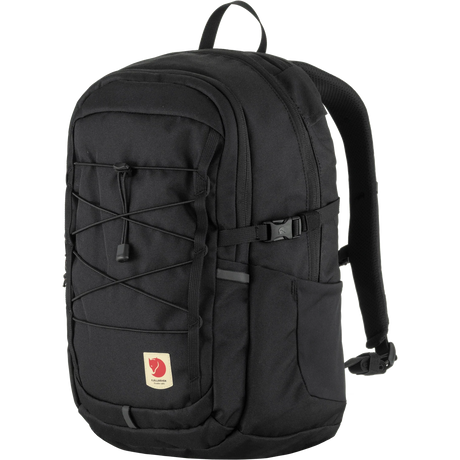 A black Fjälör backpack with multiple zippered compartments, a front lace-up strap detail, and a small red logo patch on a white background. - Fjällräven Skule 20 Backpack - Black