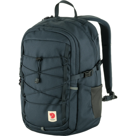 A Fjälleväl backpack in dark navy blue, featuring multiple zippered compartments, a front webbing strap system, and a side pocket, shown against a plain white background. - Fjällräven Skule 20 Backpack - Navy