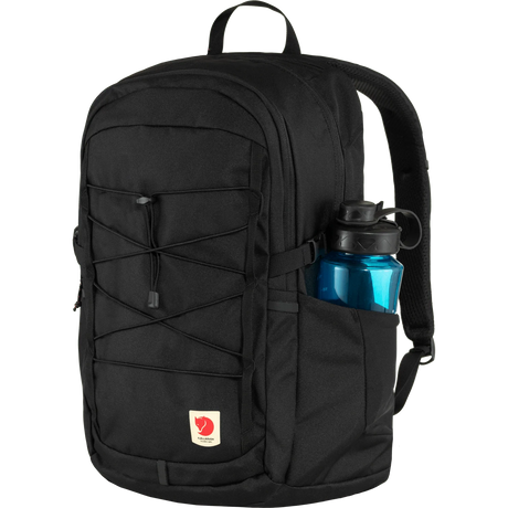 A black Fjälör backpack with a side water bottle pocket containing a blue water bottle, shown against a plain white background. - Fjällräven Skule 28 Backpack - Black