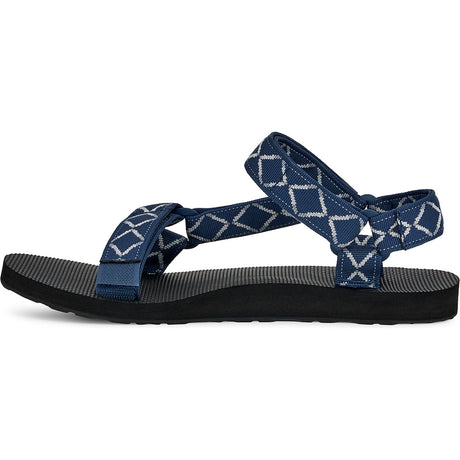 A single Teva sandal shown from the side against a plain white background. The sandal features a black textured footbed and straps made of navy blue fabric with a white geometric diamond pattern. - Teva Original Universal Sandals (Men's) - Diamond Olive