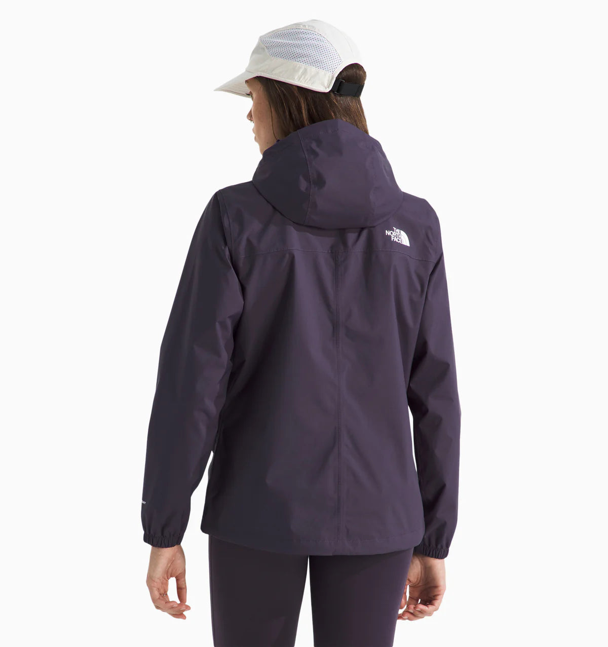 Woman wearing a the north face antora rain jacket in purple with the brand logo on the chest. with white background