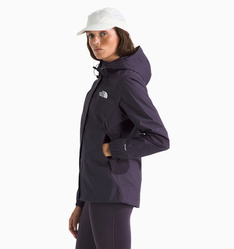 Woman wearing a the north face antora rain jacket in purple with the brand logo on the chest. with white background