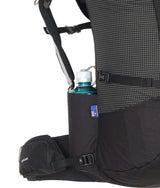 Close-up of a black hiking backpack with a side water bottle holder containing a blue water bottle, on a white background. - One Planet Tussock 60L Pack - Black
