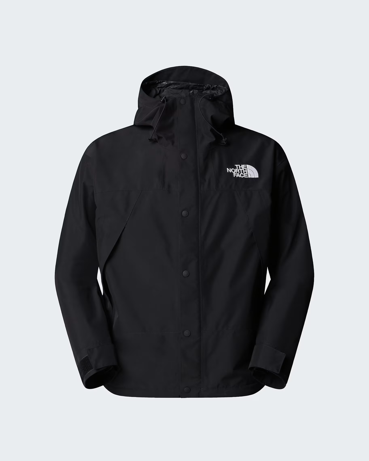 A black hooded rain jacket by The North Face, featuring a button-up front and the brand's white logo on the left chest, displayed against a light gray background. - The North Face GORE-TEX Mountain Jacket (Men's) - TNF Black/TNF Black/TNF Black