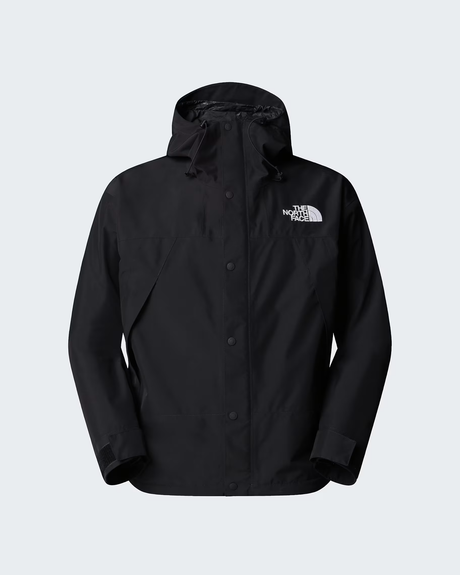 A black hooded rain jacket by The North Face, featuring a button-up front and the brand's white logo on the left chest, displayed against a light gray background. - The North Face GORE-TEX Mountain Jacket (Men's) - TNF Black/TNF Black/TNF Black