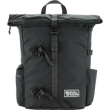A dark gray Jell Raven backpack with a top handle, roll-top zipper, and multiple black straps and buckles, shown against a plain white background. - Fjällräven Vardag Foldsack 25 - Coal Black