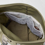 Open green bag with a white mesh pocket on a light gray background - Fjällräven Vardag Foldsack 25 - Green/Clay
