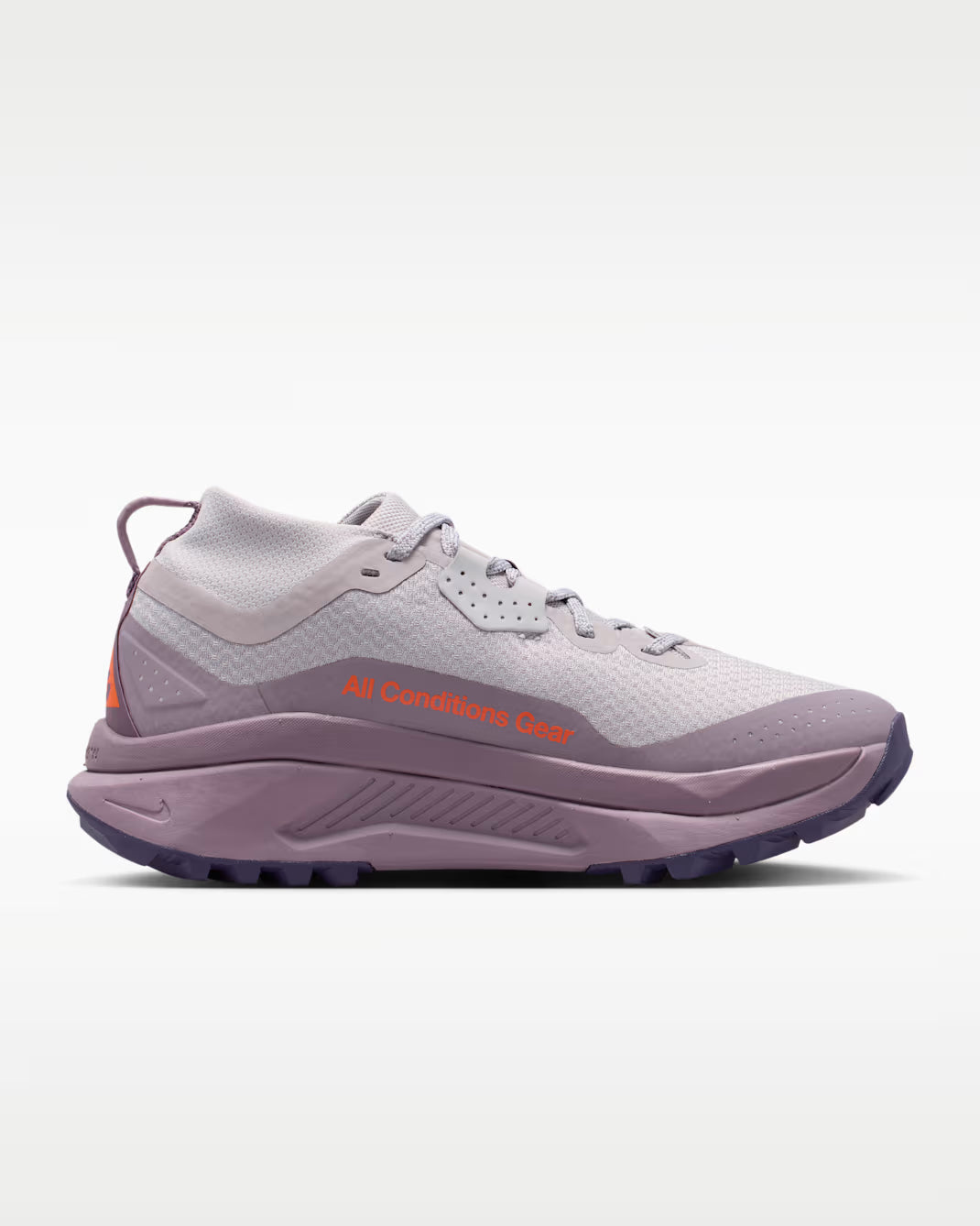 A Nike ACG ZEGAMA ZOOMX trail running shoe in a light lavender and purple colorway, featuring a textured mesh upper, a purple Swoosh, and a purple Vibram outsole, shown from a side profile on a light gray background.