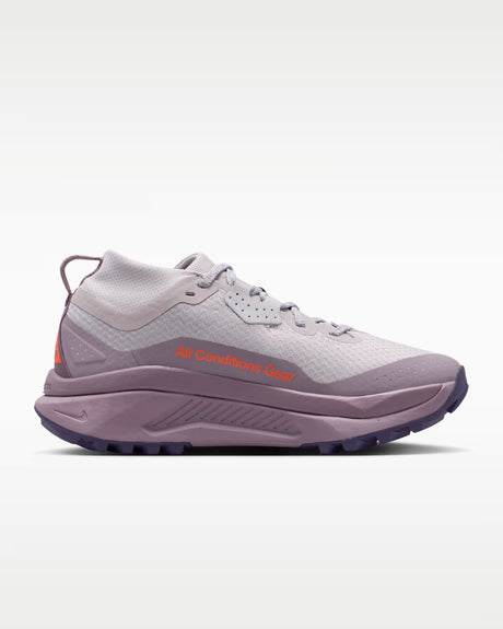 A Nike ACG ZEGAMA ZOOMX trail running shoe in a light lavender and purple colorway, featuring a textured mesh upper, a purple Swoosh, and a purple Vibram outsole, shown from a side profile on a light gray background.