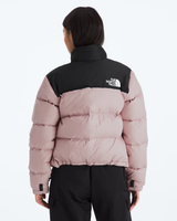 A model viewed from the back wearing a colorblock puffer jacket by The North Face. The jacket features a black upper yoke and collar, and a dusty pink body with horizontal quilting.- The North Face 1996 Retro Nuptse Jacket (Womens) - Metal Pink/TNF Black