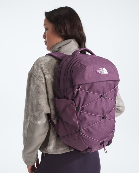 A woman shown from the back wearing a purple The North Face backpack, styled with a gray textured jacket against a plain white studio background. - The North Face Borealis Backpack (Women's) - Chroma Purple Light Heather/Hushed Lavender