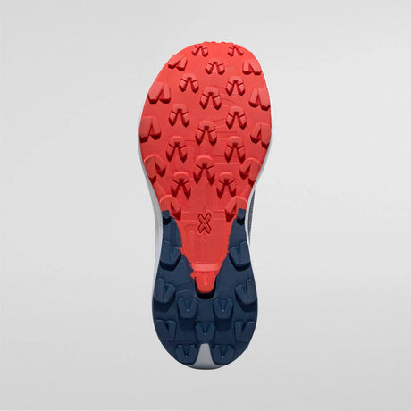 Close-up of a shoe sole with red and blue tread pattern on a light gray background - La Sportiva Prodigio Max Shoes (Men's) - Night Sky/Mountain Red