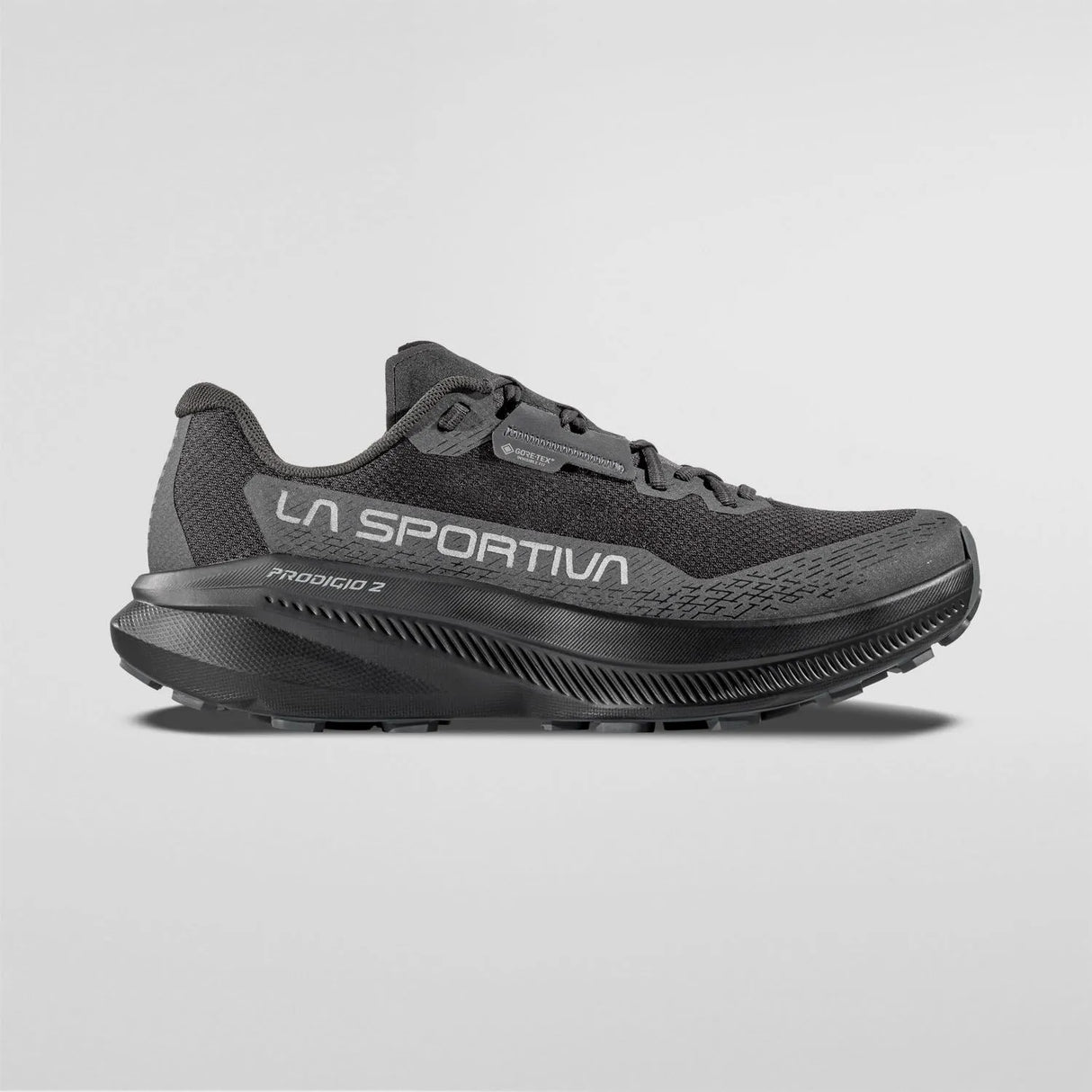 A black La Sportiva Protona 3 running shoe shown in a side profile view against a light gray background. - La Sportiva Prodigio 2 GORE-TEX Shoes (Men's) - Black/Reflective