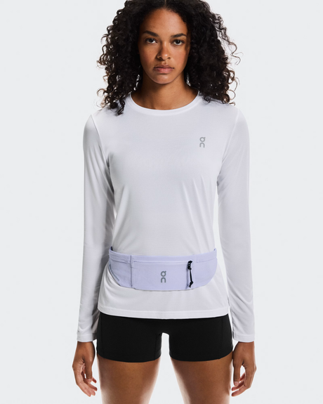 Woman wearing a light gray long-sleeve top with a matching waist bag on a white background - On Speed Belt (Unisex) - Thistle