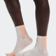 White socks with pink accents worn by a person on a white background - On Performance Run Sock Mid (Unisex) - Pearl/Sunstone