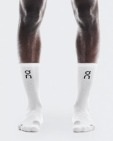 White socks with a logo on the leg worn by a person against a white - On Performance Run Sock High (Unisex) - White/Glacierbackground
