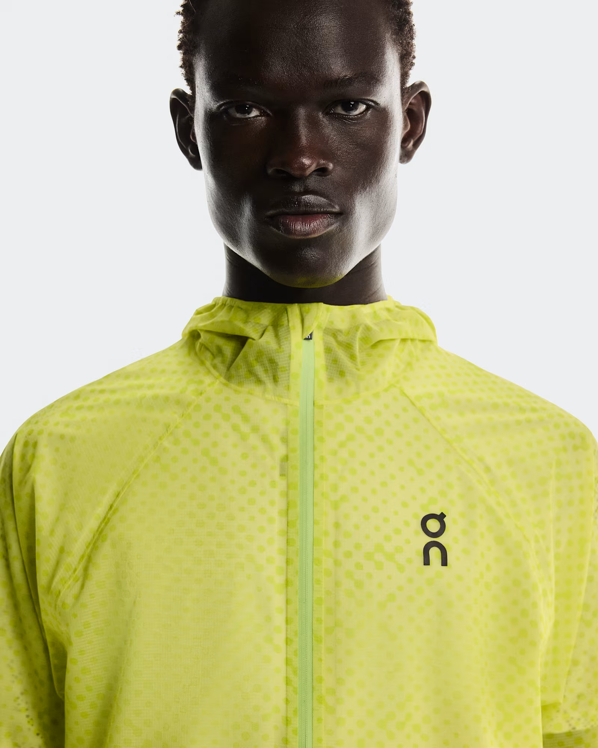 Person wearing a bright yellow jacket with a brand logo on a white background - On Ultra Jacket (Men's) - Limelight/Lime