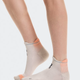 Gray ankle socks with orange accents worn by a person on a white background - On Performance Run Sock Low (Unisex) - Pearl/Sunstone