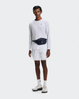 Person wearing a white long-sleeve shirt, white shorts, and a black waist bag on a white background - On Waist Pack 2L Lite - Navy