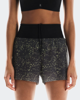 Black athletic shorts with gold star pattern worn by a person on a white background - On Ultra Shorts (Women's) - Iron/Lime