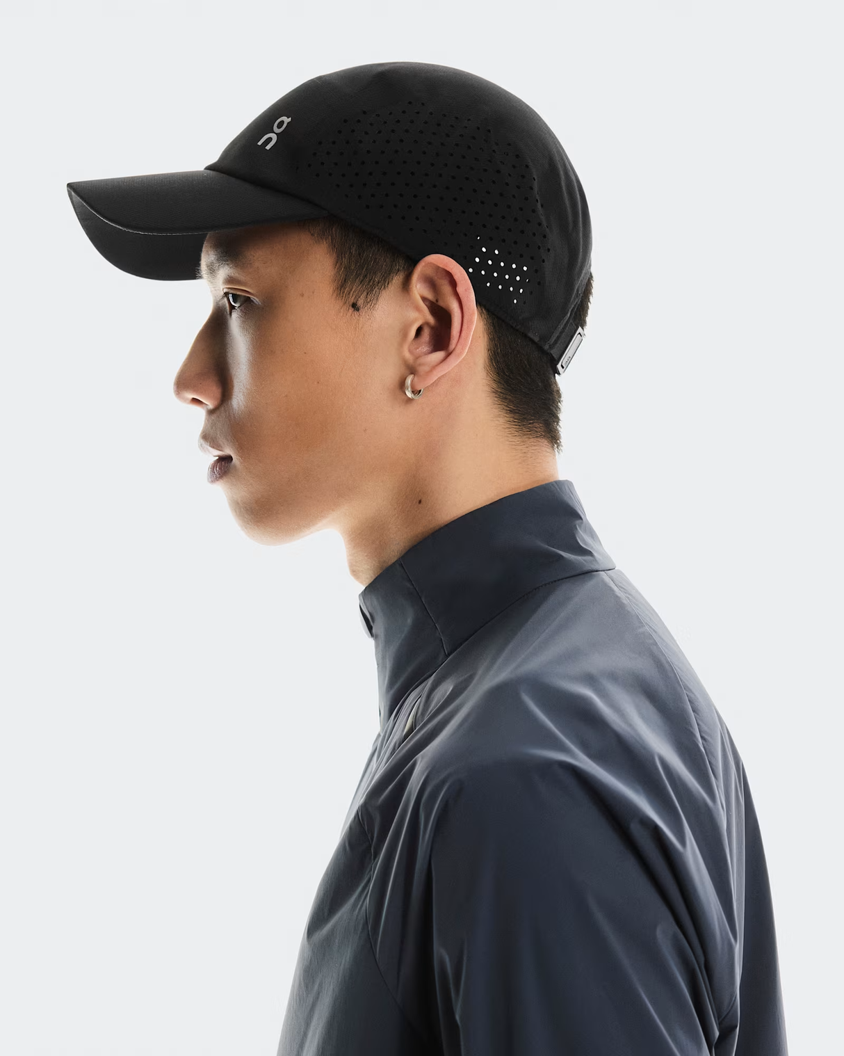 Person wearing a black cap and dark gray shirt on a white background - On Lightweight Cap - Black
