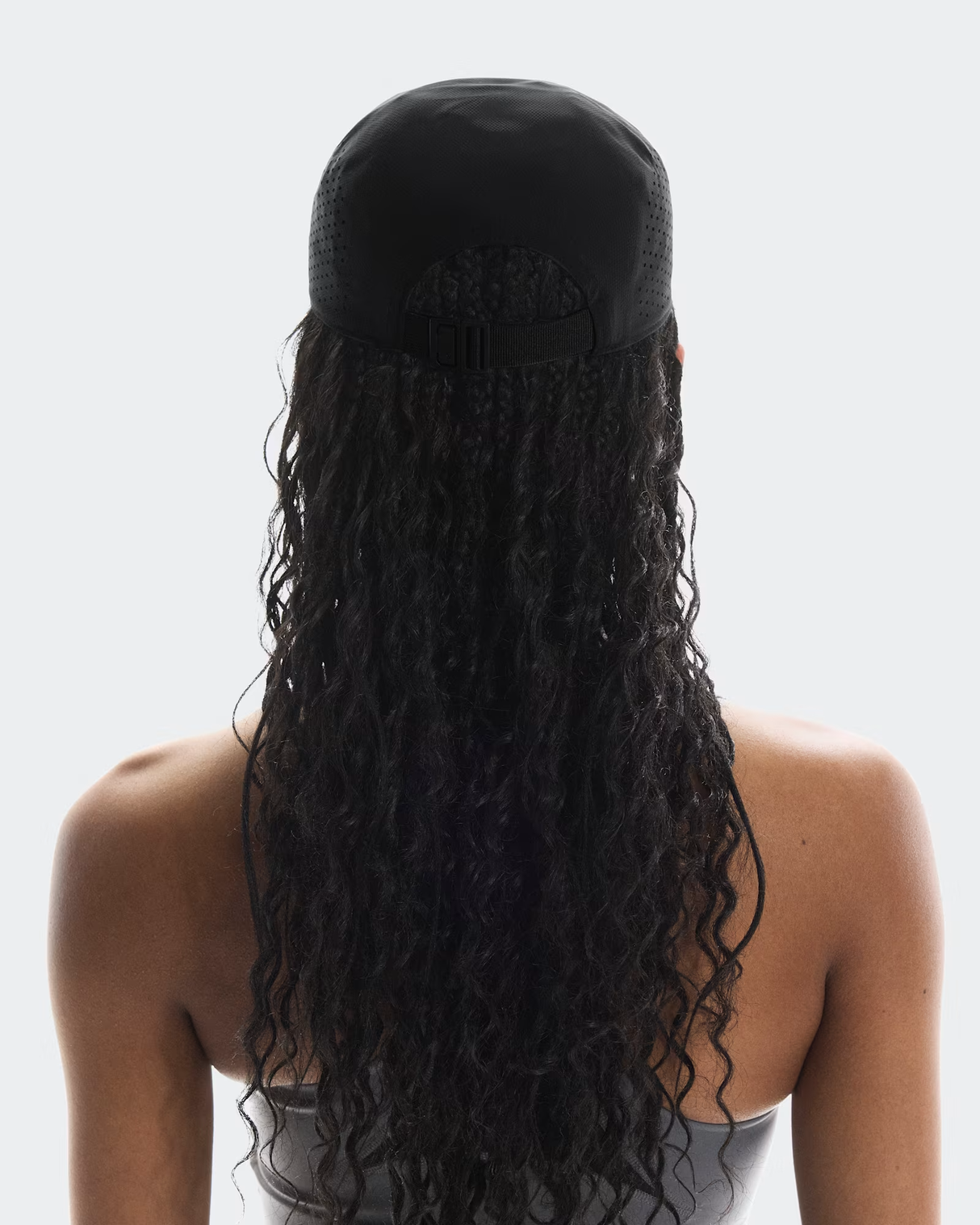 Person with long, dark hair styled in a ponytail against a white background - On Lightweight Cap - Black