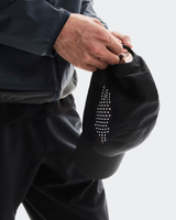 Person holding a black bag with decorative studs on a light gray background - On Lightweight Cap - Black
