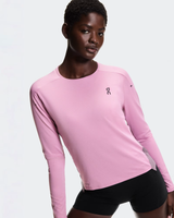 Person wearing a pink long-sleeve athletic shirt with a logo on a light gray background - On Performance Long-T (Women's) - Dewberry/Sakura