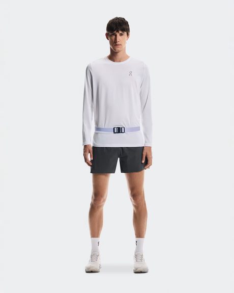 Person wearing a white long-sleeve shirt and black shorts with a visible brand logo on a white background - On Speed Belt (Unisex) - Thistle