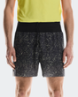 Person wearing black shorts with white speckle pattern and a yellow top on a light gray background - On Ultra Shorts (Men's) - Iron/Lime