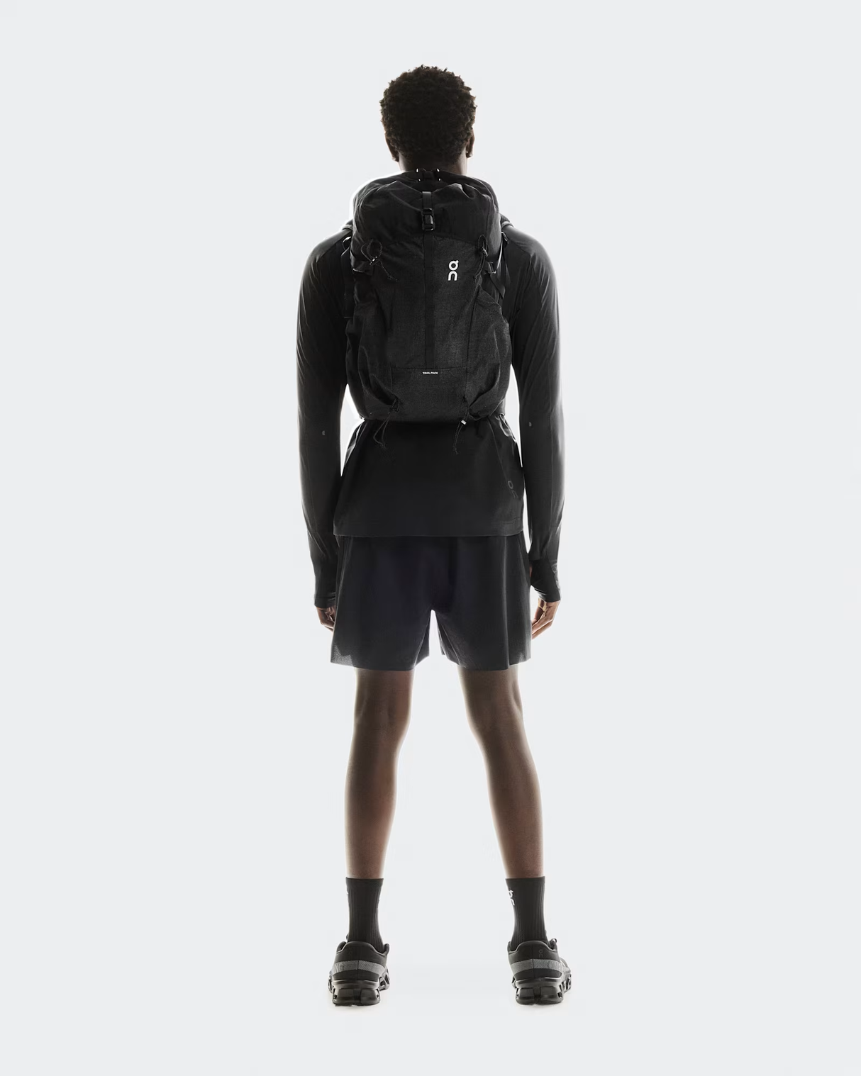 Person wearing a black backpack on a white background - On Trail Pack 20L - Black