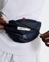 Person wearing a navy waist pack on a white background - On Waist Pack 2L Lite - Navy