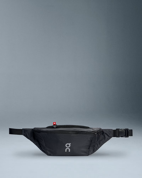 Black waist bag with a visible brand logo on a gray background - On Waist Pack 2L Lite - Magnet