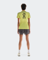 Person wearing a bright green sports outfit with 'On' branding on a white background - On Ultra Shorts (Women's) - Iron/Lime