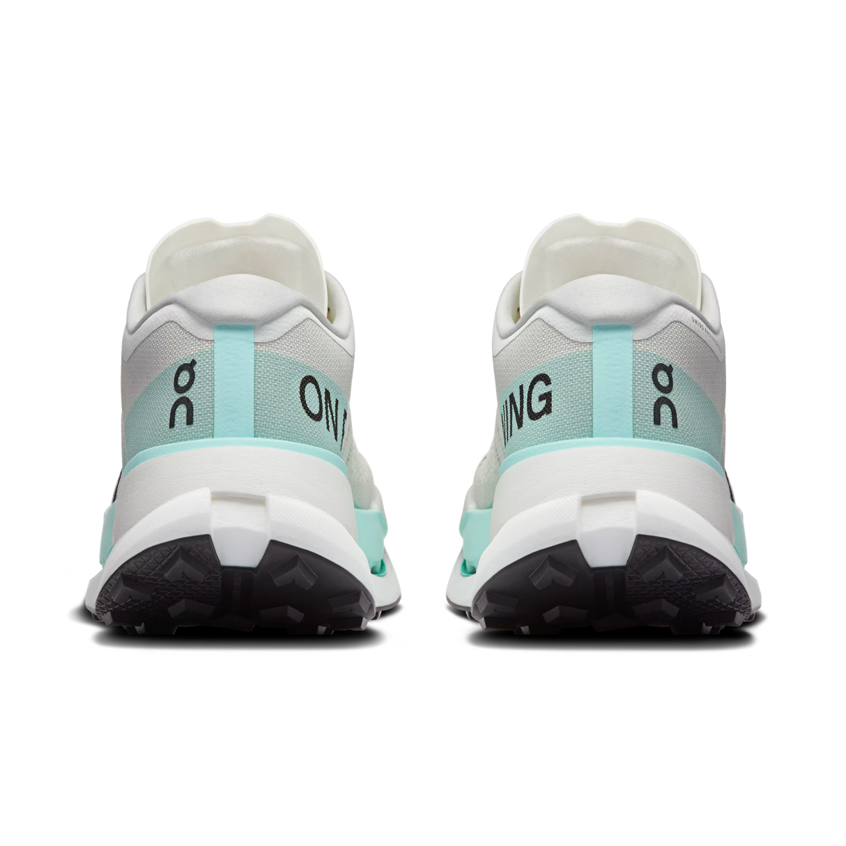 A pair of On running shoes shown from the rear, featuring a white and light mint green upper with black and white soles, set against a plain white background. - On Cloudultra Pro Shoes (Men's) - Ivory/Celeste